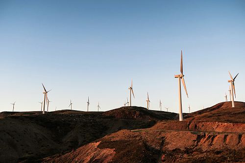 white wind turbines during daytime